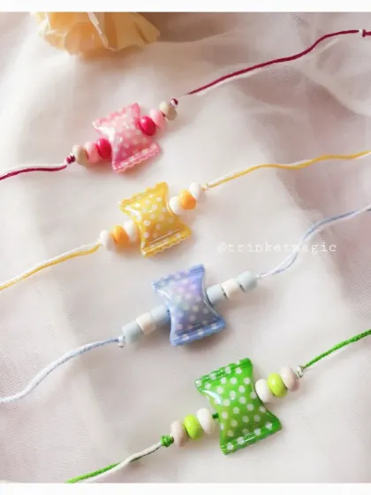 A closer look at the candy-inspired polka dot Rakhis. The pastel colors and simple wooden beads give them a sweet, handmade feel that kids love.