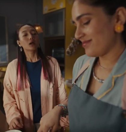 A kitchen scene from the Chumbak ad, where the styling is all about comfortable, chic loungewear with pieces like a stylish pajama set and a light robe.