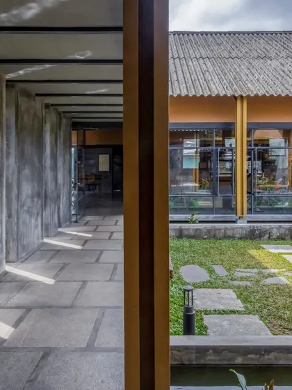 A view of the courtyard at Teyla, framed by the building's strong architectural lines and natural material palette.