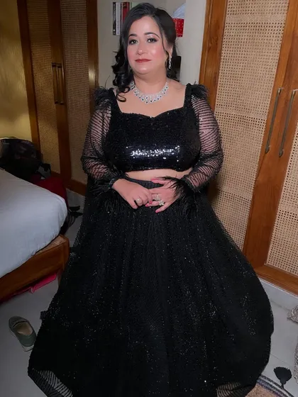The full ensemble. This black lehenga with feather details is a showstopper, and the makeup complements it perfectly.