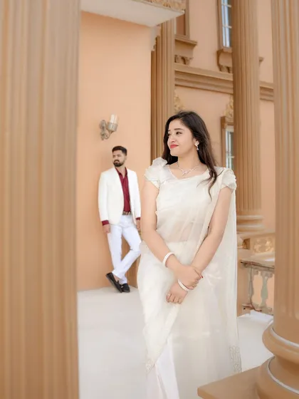 A beautifully composed shot using the pillars of the building to frame the couple. This technique adds depth and a sense of stolen glances, making the portrait feel more intimate and cinematic.