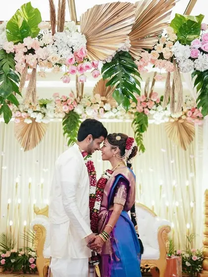 A moment of quiet connection before they are pronounced husband and wife. Framed by the beautiful floral mandap, this shot is full of anticipation and love.