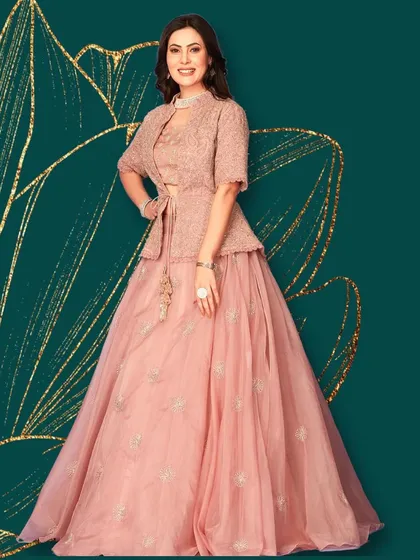 For a modern twist on traditional wear, I offer indo-western pieces like this elegant lehenga paired with a chic jacket. It's the perfect fusion of contemporary style and ethnic grace.