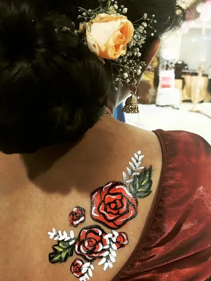 Face and body painting isn't just for kids. I also offer elegant designs for adults, like this floral piece, perfect for festivals or themed events.