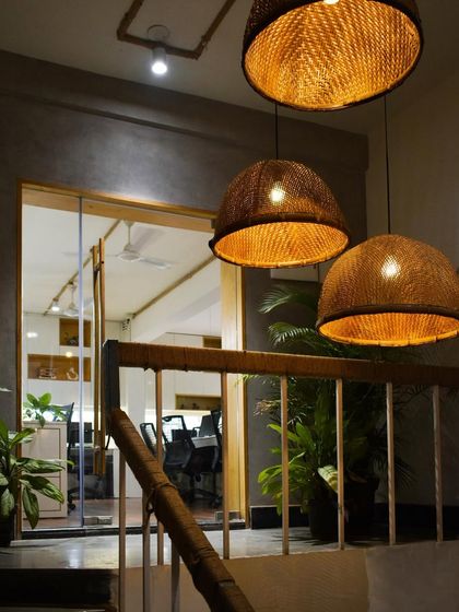 The entrance to my own architecture studio, SAS. I used a combination of concrete-textured walls, warm cane pendant lights, and indoor plants to create a welcoming and representative first impression that reflects my design ethos.