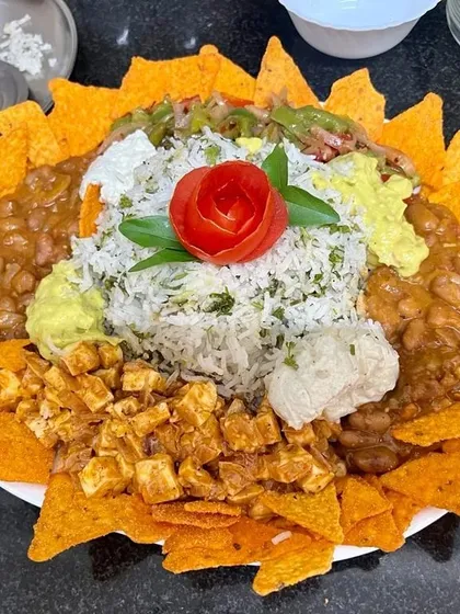 Who says healthy food has to be boring? This is my popular healthy nacho platter, made with baked chips, fresh salsa, protein-rich beans and paneer, and homemade guacamole. It's a client favorite because it's delicious, filling, and completely guilt-free.