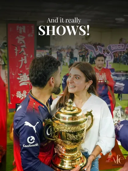 The look between them says it all. The trophy is just an object; the real prize is their partnership.