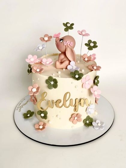 A cute floral bunny cake for little Evelyn, designed with a mix of soft colors, delicate flowers, and a sweet, hand-sculpted bunny topper.