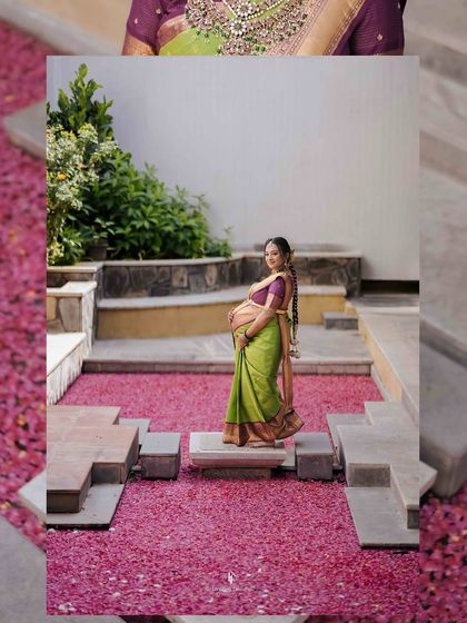 An artistic shot of the mother-to-be standing in a courtyard filled with pink flower petals. This creative composition adds a touch of romance and celebration to the maternity portrait.