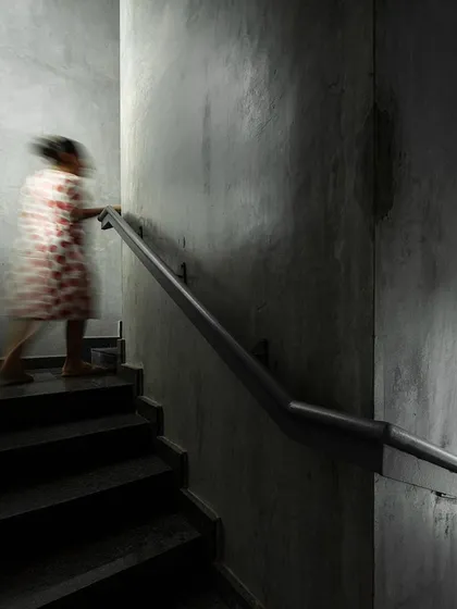 A duplicate of the previous image, this motion-blurred shot captures the feeling of moving through the stark, atmospheric stairwell of our studio, a space designed for quiet transition.