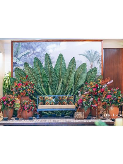 A stunning backdrop for a Pellikuthuru ceremony, created by weaving giant coconut leaves into a fan shape. This unique design element is both culturally significant and visually striking.