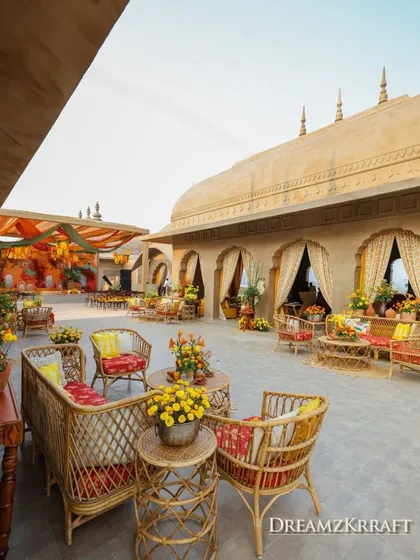 An overview of the Haldi venue, showing how the warm, earthy tones and traditional Indian furniture create a cohesive and inviting atmosphere that honors the cultural theme.