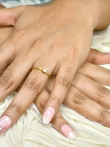 A closer look at the elegant rose gold glitter ombre, showing the seamless blend on long, almond-shaped nails.