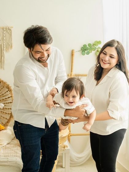 Pure joy and movement. This candid shot of the family playing together captures the energy and happiness of their bond.