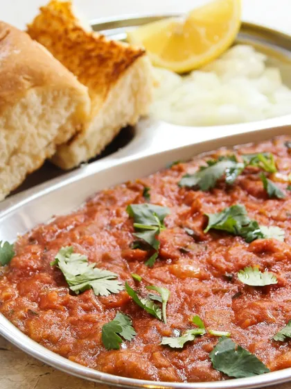 Another look at our authentic Pav Bhaji, served in a traditional steel plate. We ensure the taste is just right, bringing the authentic flavor of Mumbai street food to your party.
