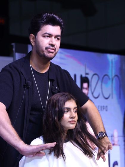 A moment of intense focus while cutting hair live on stage. Precision and technique are everything, especially when all eyes are on you.