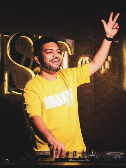 Throwing up a peace sign to the crowd. It's all about good vibes and great music.