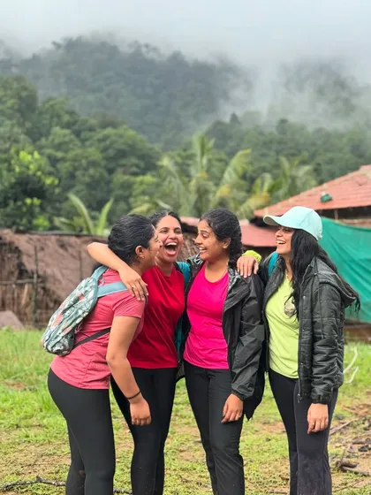 A group of friends laughing and enjoying the moment at their homestay before the Kodachadri trek.