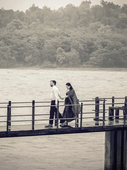 A quiet walk on a jetty, captured in timeless black and white. The misty, moody atmosphere of the monsoon adds a layer of romance and nostalgia to the scene.