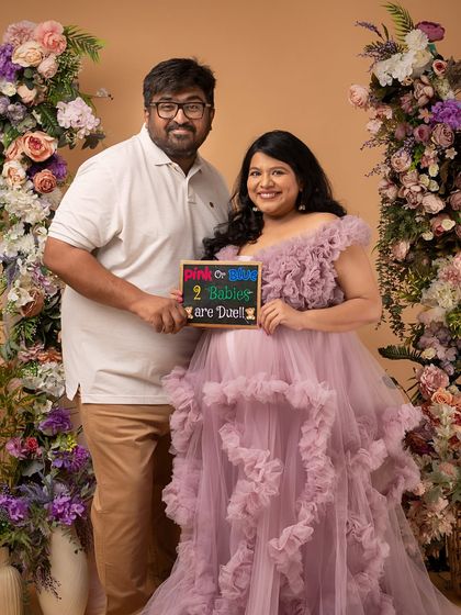 A proud portrait of the parents-to-be, announcing their twin pregnancy. Their happiness is absolutely radiant.