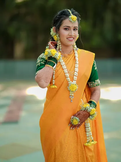A radiant bride during her Haldi ceremony. I love capturing these solo portraits, focusing on the joy and anticipation of the bride, adorned in traditional floral jewelry and glowing with happiness.