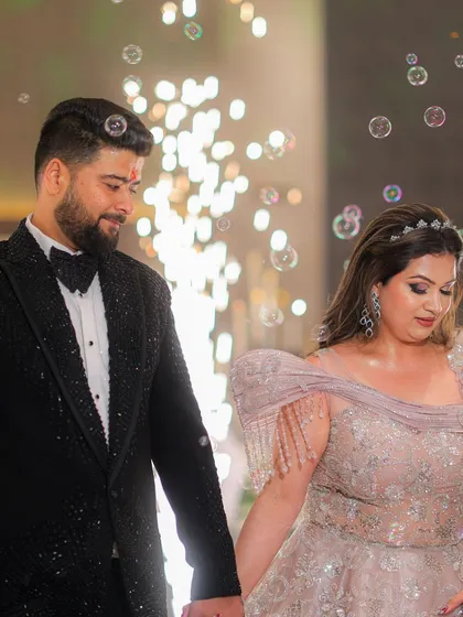 A sweet, candid moment between the couple. The bride's makeup is soft and romantic, perfect for this intimate shot.