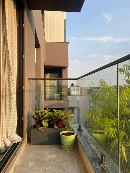 A view of a recent balcony project where I used a mix of planters to add life to the space. The combination of colorful Crotons and other foliage plants creates a vibrant and welcoming atmosphere.