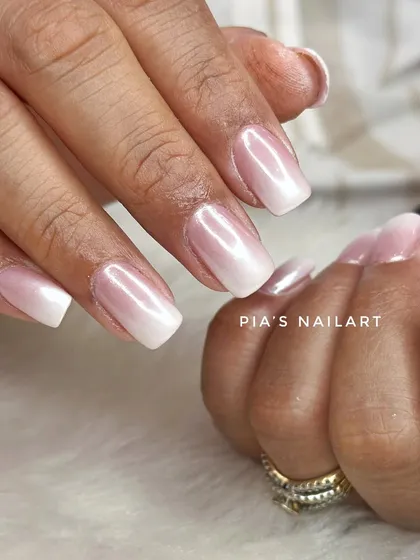 Simple yet stunning. These airbrushed ombre nails are topped with a pearl chrome glaze, giving them a beautiful, iridescent finish.