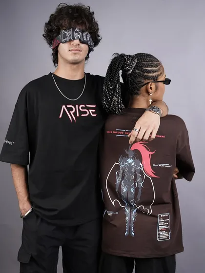 A stylish pose showcasing both the front and back graphics of the 'ARISE' collection. The blindfold adds a mysterious, edgy vibe to the shot, making it stand out.