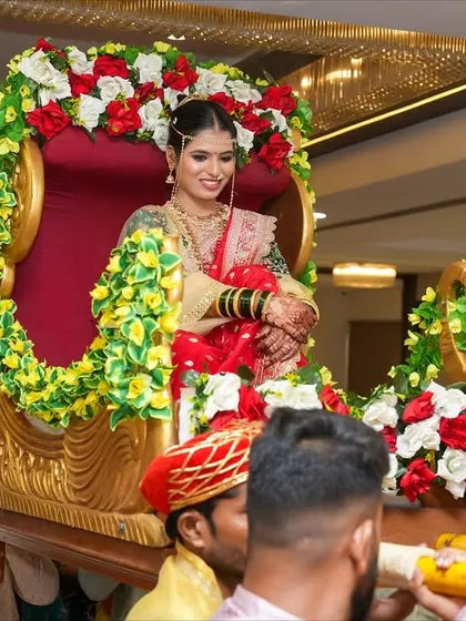 Another angle of the bride's entry in a doli. Her soft, natural makeup looks stunning even from a distance.