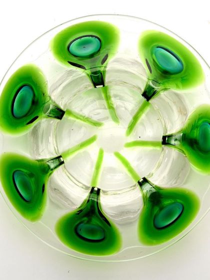 A top-down view of the Bohemian glass bowl, clearly showing the circular arrangement of the peacock feather motif.