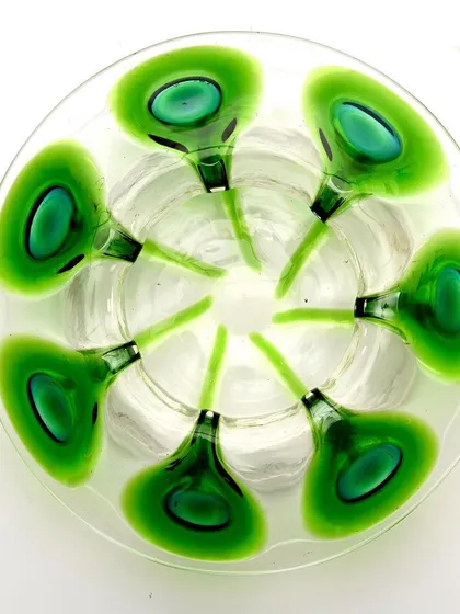 A top-down view of the Bohemian glass bowl, clearly showing the circular arrangement of the peacock feather motif.