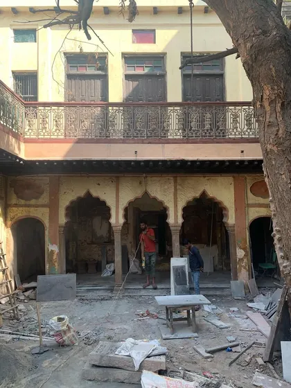 Laying the new stone floor in the courtyard, a crucial phase of the project that required precision and skilled craftsmanship.