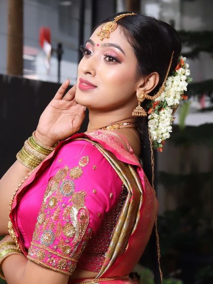 A close-up on the side profile, focusing on the intricate details of the embroidered blouse, the hairstyle, and the flawless skin finish.