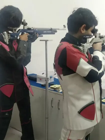 Two of our young rifle shooters practicing side-by-side, learning from each other and pushing their limits.