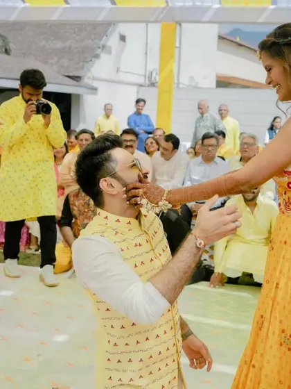 The groom proposes to his bride during the Haldi ceremony, a sweet and unexpected romantic gesture.