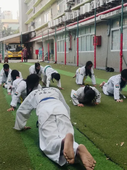 Another angle of our synchronized push-up drill. The collective effort builds a strong team spirit.