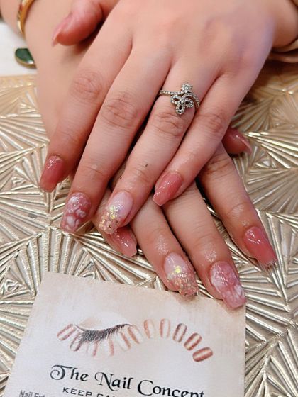 A duplicate of image 82, showing a soft and romantic look with long square nails in a dusty rose color. The accent nails feature a marbled effect with gold foil flakes for a touch of luxury.