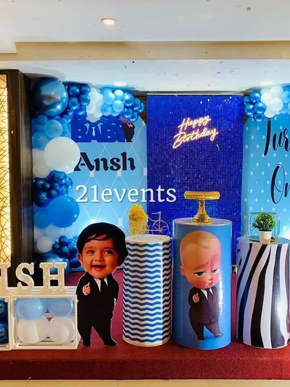The Boss Baby theme is perfect for a little one's big day. This decoration package includes character cutouts, a blue and white balloon arrangement, a personalized backdrop with a neon sign, and themed dessert stands.