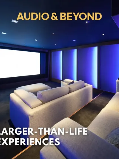 We create larger-than-life experiences. This home cinema design uses ambient blue lighting on the acoustic wall panels to create a futuristic and immersive atmosphere, perfectly complementing the large, bright screen.