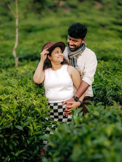 A playful and romantic moment captured in a tea garden, this photo showcases how natural surroundings can enhance the story of a couple's love.