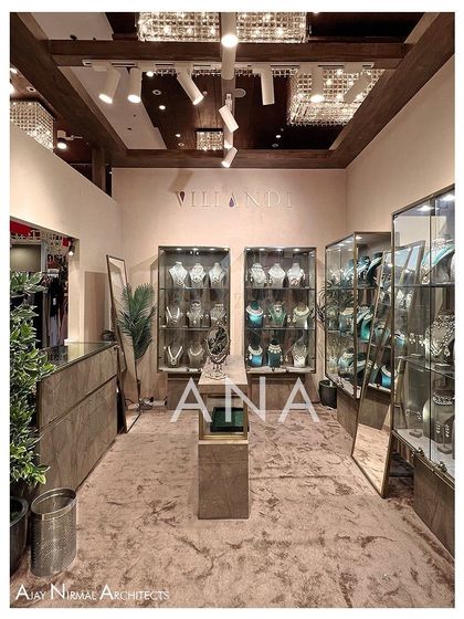 An interior view of the Villandi '22 stall, showing the arrangement of the custom jewellery display cases. The plush carpeting and focused track lighting create an intimate and high-end retail atmosphere.