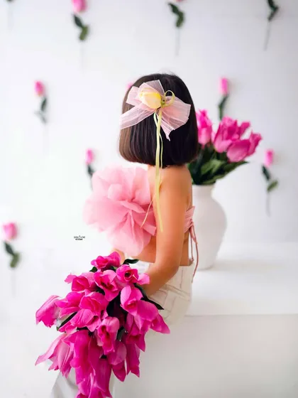A beautiful detail shot from the back, showing off her cute bob and pretty hair bow.