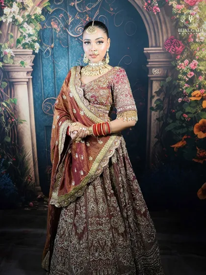 This bride radiates elegance in her traditional attire. The makeup features a soft glam eye, perfectly defined brows, and a warm skin finish that looks both natural and polished.