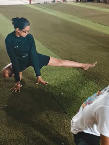 An adult student works on her flexibility. Our classes provide a balanced workout that includes strength, cardio, and deep stretching for overall fitness.