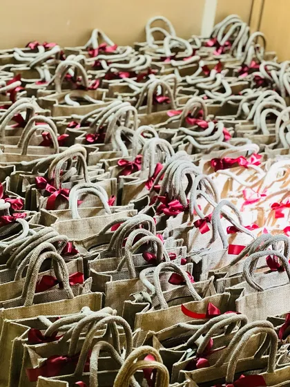 Scale and consistency are key for corporate orders. Here are hundreds of eco-friendly jute bags, each filled and ready for a large corporate event, showing my capability to handle bulk gifting requirements.