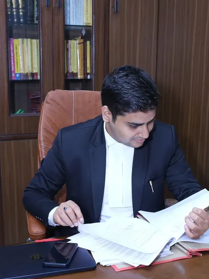Reviewing case files and legal documents at my desk. I personally go through all the paperwork to ensure nothing is missed, which is crucial for matters like property disputes and contract law.