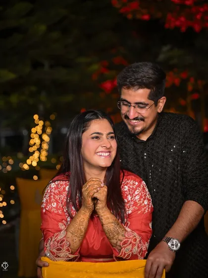 A joyful portrait of the couple under the warm lights of their Mehandi night celebration.