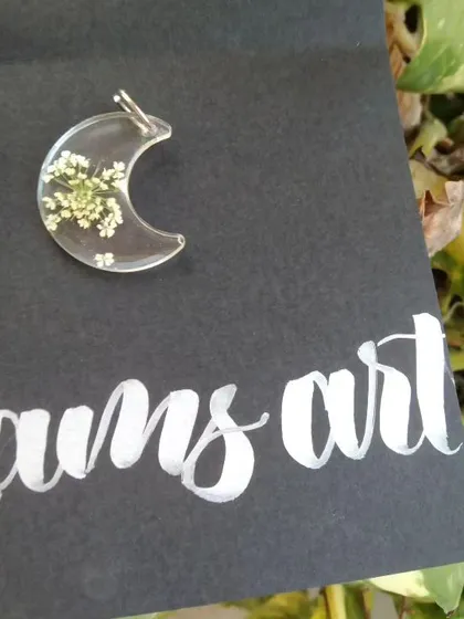 A crescent moon pendant with preserved baby's breath. This is one of my most requested shapes.