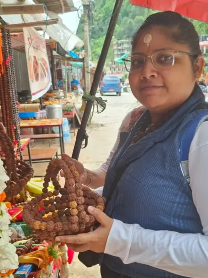 A pilgrim exploring the local market near the temple, holding a basket made of Rudraksha beads, which are sacred to Lord Shiva.